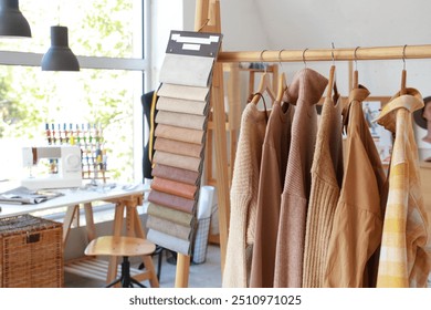 Clothes rack with fabric samples in fashion designer's studio - Powered by Shutterstock