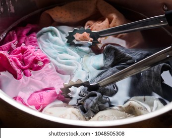 Clothes Are Soaking In A Pot Of Hot Water And Detergent For Washing By Hand.