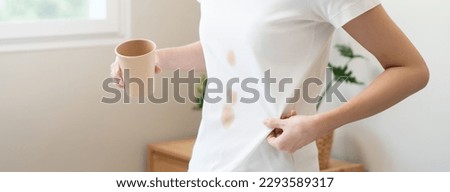 Clothes stain dirty from food concept, people get a coffee drop split from glass on the t-shirt.
