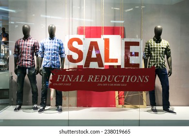 Clothes Storefront Window With Sale Poster