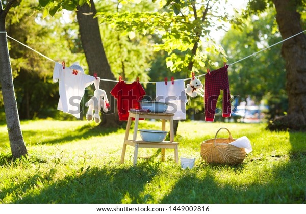 clothes and toys hanging on the\
clothesline in the summer outdoors. accessories to\
washing