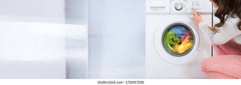 Clothes Wash In Washing Machine Or Dryer. Woman Doing Laundry