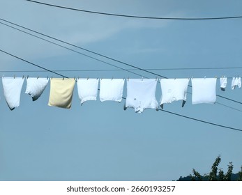 Clothesline between two buildings. Drying clothes in the wind