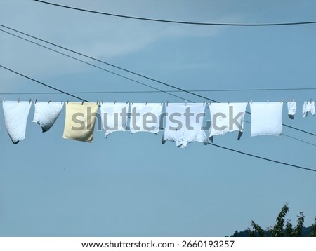 Clothesline between two buildings. Drying clothes in the wind