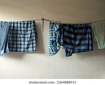 clothesline in the form of a typical Indonesian sarong that is dried on a rope
				
				