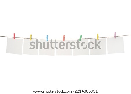 Clothespins with empty notepapers on string against white background. Space for text