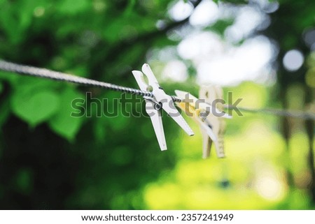 Clothespins on a clothesline in summer. Dry clothes outside. Clothes on rope.