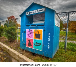 Clothing bin big blue metal box with signs Reuse and recycle, clothes and shoes,  Hutchinson River Parkway, very wide angle panorama, New York, Bronx, 10462, United States of America, 11.02.2021