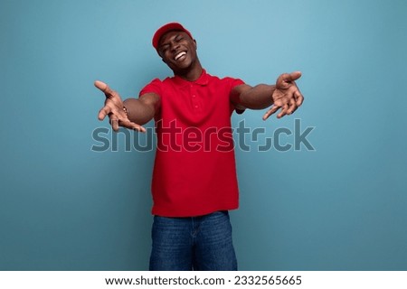 clothing for identity and branding. successful young handsome american man in red t-shirt and cap