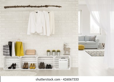 Clothing Rack Hanging On A Wall, Shoe Racks Made From Wooden Boxes, Light Room In The Background