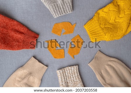 Clothing recycling. Used clothes. Ecological and sustainable fashion. sleeves of autumn woolen sweaters. reduce waste concept. High quality photo