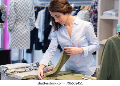 Clothing Shop Worker Folding Cloth