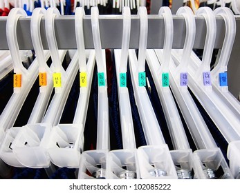 Clothing Sizes - Multiple Coat Hangers In A Store With Size Tags