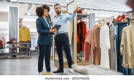 Clothing Store: Businesswoman Uses Tablet Computer, Talks To Visual Merchandising Specialist, Collaborate To Create Stylish Collection. Small Business Fashion Shop Sales Manager Talks To Designer.