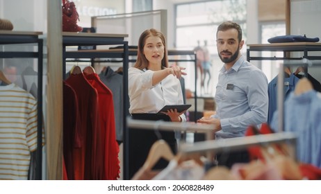 Clothing Store: Businesswoman Uses Tablet Computer, Talks To Visual Merchandising Specialist, Collaborate To Create Stylish Collection. Small Business Fashion Shop Sales Manager Talks To Designer