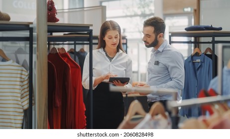 Clothing Store: Businesswoman Uses Tablet Computer, Talks to Visual Merchandising Specialist, Collaborate To Create Stylish Collection. Small Business Fashion Shop Sales Manager Talks to Designer