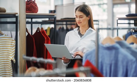 Clothing Store: Businesswoman And Visual Merchandising Specialist Uses Laptop To Create Stylish Collection. Fashion Shop Sales Retail Manager Checks Stock. Small Business Owner And Designer Works