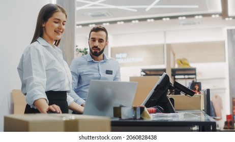 Clothing Store Checkout Cashier Counter: Female And Male Retail Sales Managers Carefully Packing Online Ordered Clothes Into Boxes. Fashionable Shop, With Stylish Brand Designs Available On Internet