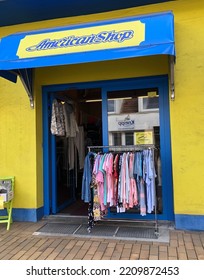 Clothing Store Entrance. Clothes On A Hanger Are Displayed On The Street Outside The Store. Neumünster, Schleswig Holstein, Germany - September 22, 2022