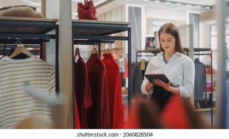 Clothing Store: Female Visual Merchandising Professional Uses Tablet Computer To Create Stylish Collection. Fashionable Shop Sales Retail Assistant Checks Stock. Small Business Owner Orders Items