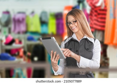 Clothing Store, Female Visual Merchandising Specialist Uses Tablet Computer