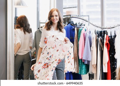 Clothing Stylist Young Woman Chooses Clothes In A Store