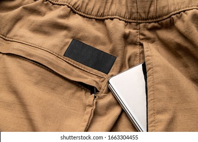 Clothing Tag, Label Blank Mockup Template, To Place Your Design. On Outdoor Streetwear Pants, With Smartphone