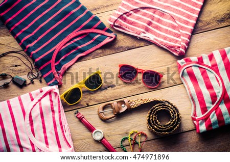 clothing for women, placed on a wooden floor.