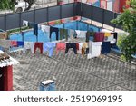 cloths drying on a clothline on a roof in neighborhood 