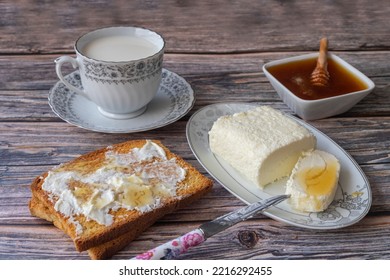 Clotted cream (butter cream) for Turkish breakfast - Kaymak, honey and glass of milk - Shutterstock ID 2216292455
