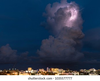 Cloud blossoms while lightning bursts through