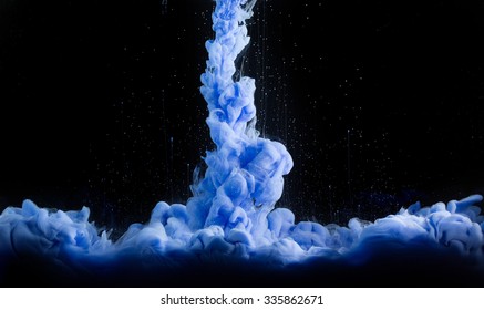 Cloud of colorful shiny ink isolated on black background.