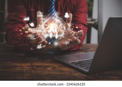 Cloud computing with AI and internet networking transfers worldwide information. Businessman holding virtual earth on hand with cloud computing global internet connection application technology.
