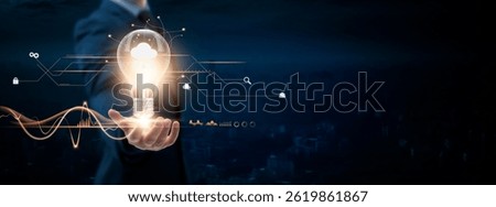 Cloud Computing: Businessman Holding Creative Light Bulb with Digital Networking and Cloud Computing Icon. Innovation, Connectivity, Advancing Technology, on Blue City Background.