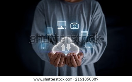 Cloud computing and communication concept, Man hands holding the virtual screen of cloud with equipment for communicating trough information on clouds. Data storage.