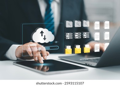 Cloud computing concept. Businessman uses a tablet and laptop with digital cloud storage and data icons, suggesting cloud-based data management. upload and download. digital service. data center. 