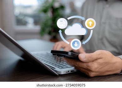 Cloud computing concept with digital icons showing data upload, download, and document sync above smartphone and laptop. Cloud storage, data transfer, backup, and business technology.