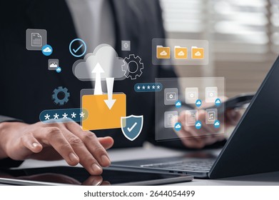 Cloud computing data transfer and secure storage system in business environment with man managing files on laptop and tablet for digital workflow and privacy protection across internet platforms.