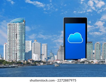 Cloud computing icon on modern smart mobile phone screen over office city tower, river, skyscraper and blue sky, Technology cloud computing concept