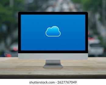Cloud computing icon on modern computer monitor screen on wooden table over blur of rush hour with cars and road in city, Technology cloud computing concept