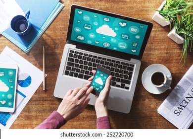 Cloud computing and social network interface on a laptop, tablet and smartphone screen - Powered by Shutterstock