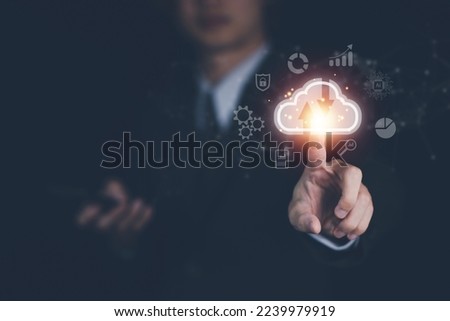 Cloud computing technology concept with businessman. Big data analytics and business intelligence concept with chart and graph icons on a digital screen interface.