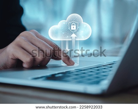 Cloud computing technology management concept. Cloud with digital lock icons appearing while business people working with laptop computer, transfer data by finger on touchpad. Protection and security.