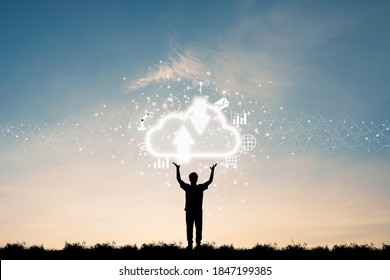 Cloud Computing And Technology Transformation Concept , Silhouette Of Businessman Standing And Two Rise Hand Up For Holding Virtual Cloud Computing And Icons.