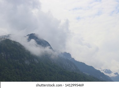 Cloud covering one portion of mountain 