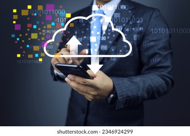 Cloud data concept. Businessman using smart phone to download and upload data into cloud computing, binary numbers floating around showing data access anywhere with high speed internet signal.
