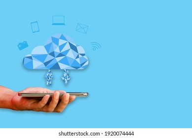 Cloud data storage concept. Hand-holding smartphone or mobile with Polygon cloud computing and icons transfer data on blue background. Communication of business and financial. 