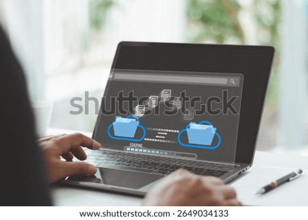 Cloud data transfer and file sharing, digital folder backup and document migration system. Hand using laptop to transfer data files between cloud storage folders, online digital document management.