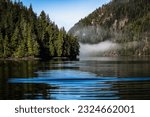 A cloud floats on the stillness of a lake. Cameron Lake on Vancouver Island. Tofino is a district municipality of Canada, located on Vancouver Island in British Columbia, in the Alberni - Clayoquot Re