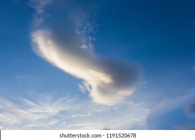 A cloud in the form of a penis against a blue sky
